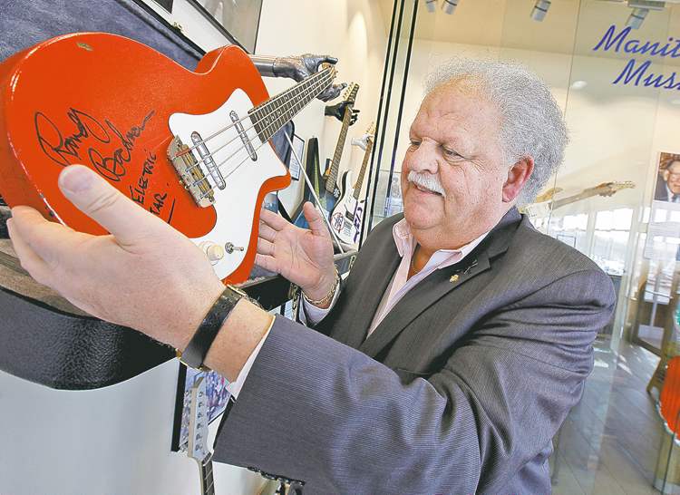 John Woods / Winnipeg Free Press
Earl Barish holds Randy Bachman's first electric guitar, one of the items on display in the new Salisbury House restaurant.
