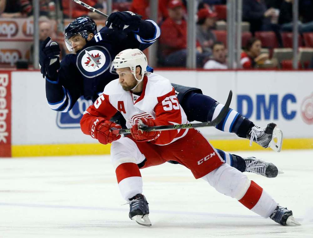 Duane Burleson / The Associated Press
Winnipeg’s Blake Wheeler is tripped up by Detroit blue-liner Niklas Kronwall during third-period action Thursday night.
