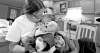 Photos by Ruth Bonneville / Winnipeg Free PressDianne Traverse kisses her two-month-old baby Bradley, who was born while she was still living in Winnipeg along with her sons Cullen (in photo) and Gordon.