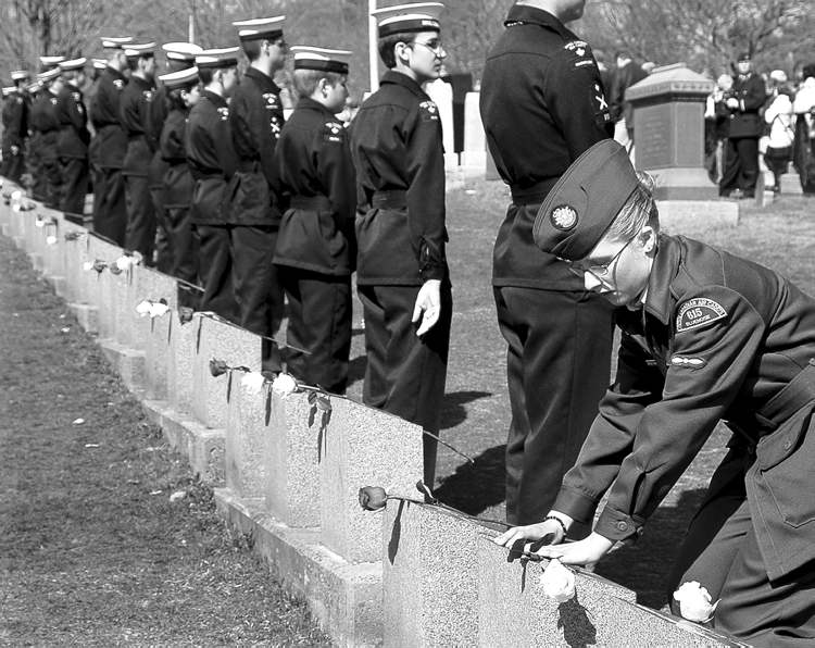 CP
Leading Air Cadet Sharon Spears-Mandeville lays a flower on a grave marker at the memorial service at Fairview Lawn Cemetery in Halifax Sunday.