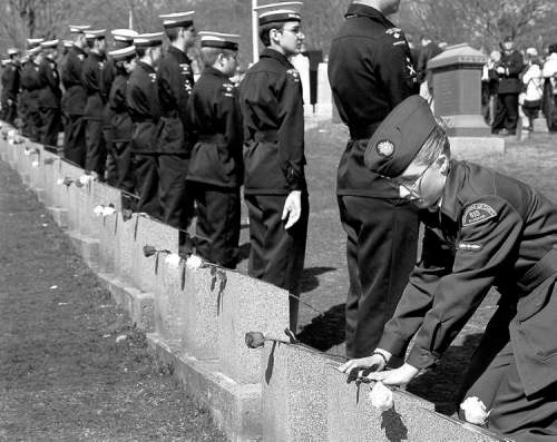 CP
Leading Air Cadet Sharon Spears-Mandeville lays a flower on a grave marker at the memorial  service at Fairview Lawn Cemetery in Halifax Sunday.