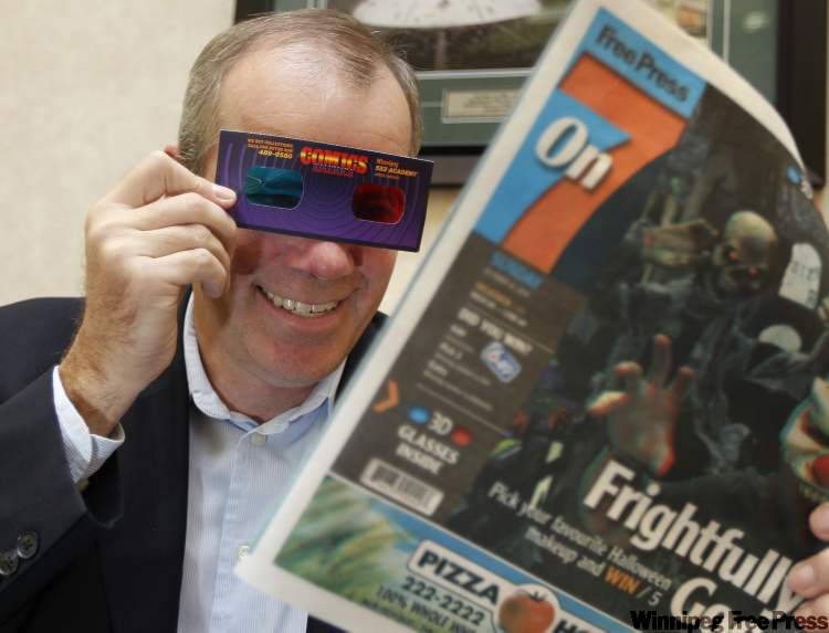 Ruth Bonneville / Winnipeg Free Press
Winnipeg Free Press Publisher Bob Cox uses 3-D glasses to read a prototype of Sunday's On7 paper which will be printed in 3-D.