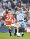 CP
jon super / the associated pressManchester City�s Vincent Kompany battles against Manchester United�s Paul Scholes Monday. Kompany scored the lone goal as Man City won 1-0.