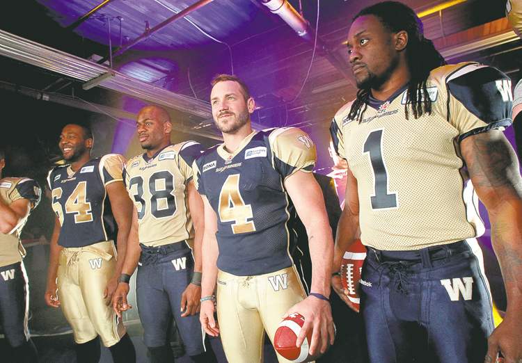 MIKE DEAL / WINNIPEG FREE PRESS
Bomber players model the new Winnipeg Blue Bombers jerseys on Tuesday at the Pan Am Boxing Club.