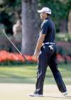 John Raoux / the associated press
Tiger Woods drops the putter on 13 after a birdie effort fails.