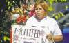 TREVOR HAGAN / WINNIPEG FREE PRESS 
Amanda Sinclair attends a vigil Sunday for her sister, Carolyn, at the spot where her body was found in the West End.