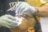melissa tait / winnipeg free press
Blue Bombers dentist Gene Solmundson checks to see whether defensive end Kenny Mainor flossed regularly during the off-season.