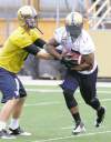MIKE DEAL / WINNIPEG FREE PRESS
mike deal / winnipeg free press
QB Alex Brink hands off to Chad Simpson Sunday morning as Blue Bomber camp kicked off at Canad Inns Stadium.