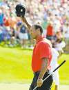 CP
jay laprete / the associated pressTiger Woods waves to the crowd after making a birdie putt on the 18th.