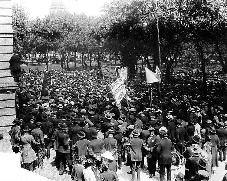 Soldiers recently returned from the First World War gather outside a government building