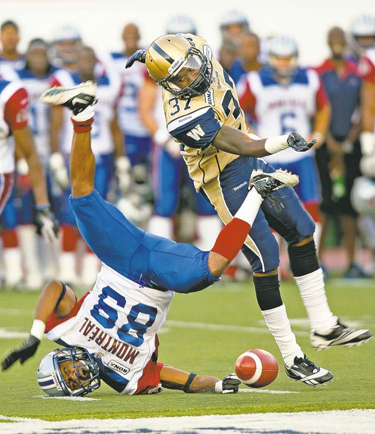 Ryan Remiorz / the canadian press
Alouettes receiver Travon Patterson is sent flying by Blue Bomber defensive back Demond Washington on Thursday. Washington has been impressive.
