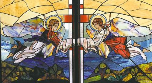 JOE BRYKSA/WINNIPEG FREE PRESS
Grim images of the Holodomor make a stark contrast to the exquisite stained glass windows by artist Ben Wasylyshen at the Holy Family Nursing Home.