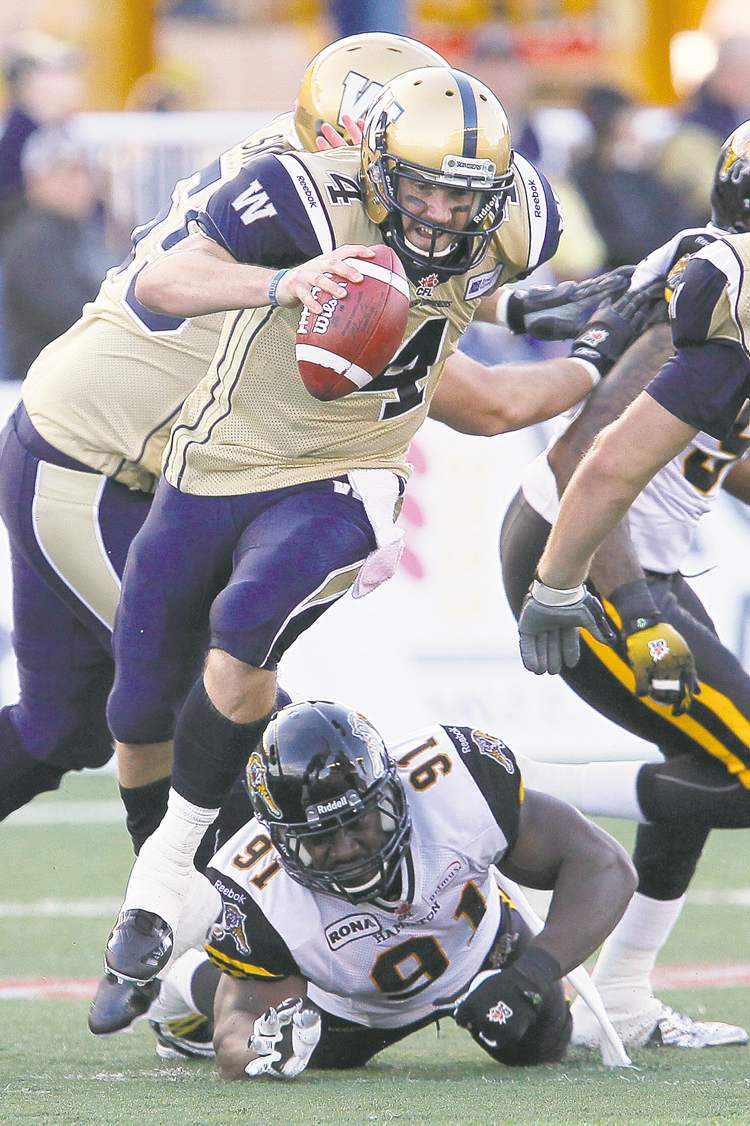 John Woods / The Canadian Press archives
Bombers' starting pivot Buck Pierce eludes Ticats' Brandon Boudreaux in their June 20 pre-season game. Pierce has a couple of promising targets to throw to this year in Kito Poblah and Chris Matthews.