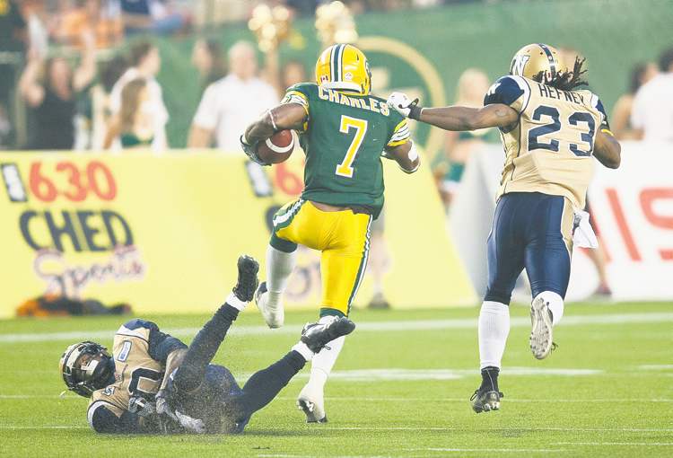 john ulan / the canadian press
Neither Johnny Sears (left) nor Jonathan Hefney can catch Edmonton Eskimos' Hugh Charles on this 76-yard TD run.