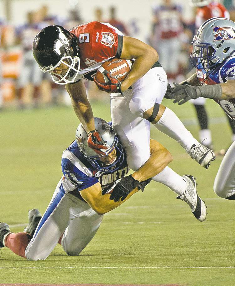 CP
paul chiasson / the canadian press
Alouettes linebacker Chip Cox grabs Stampeders rusher Jon Cornish in a July 12 game the Stamps barely won.