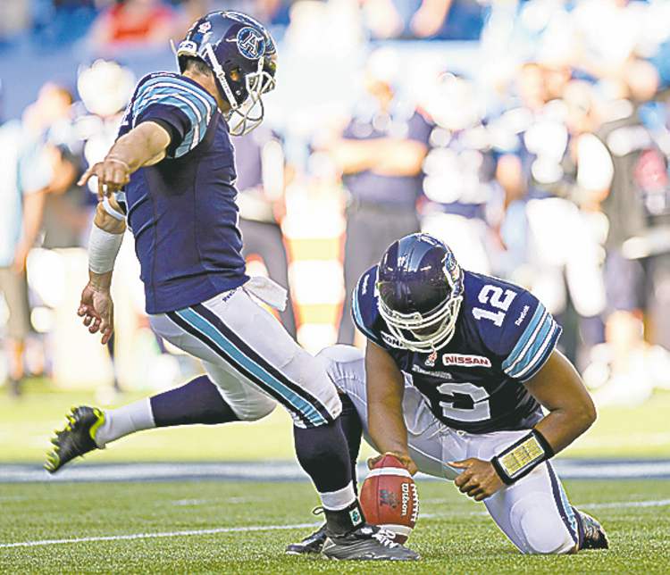 CP
frank gunn / the canadian press
QB Jarious Jackson holds, Noel Prefontaine kicks field goal.