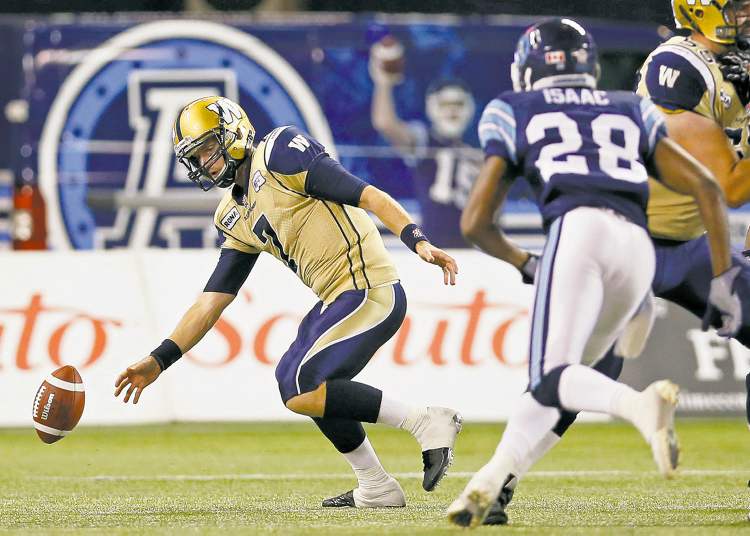 Mark Blinch / reuters
The ball slips from quarterback Alex Brink's hands as Argos' Brandon Isaac comes charging in during the second half Wednesday night at Rogers Centre.