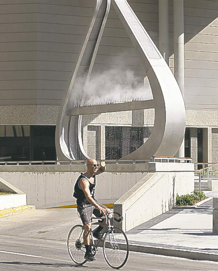 KEN GIGLIOTTI / WINNIPEG FREE PRESS
A cyclist passes by the cloud fountain emptyful at the official opening of the Millennium Library Park.