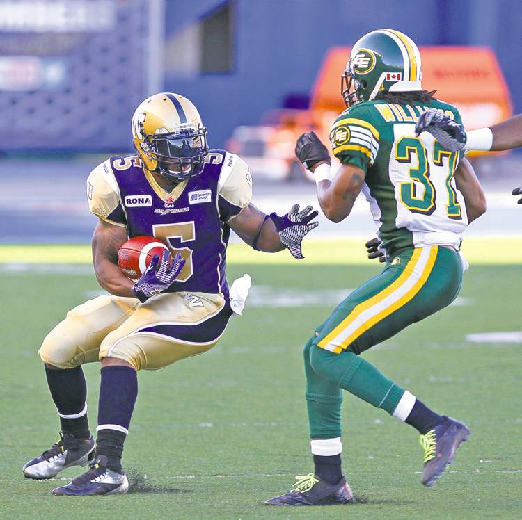 MIKE DEAL / WINNIPEG FREE PRESS
MIKE DEAL / WINNIPEG FREE PRESS
Bombers� Chad Simpson looks to run the ball past Edmonton defender Rod Williams at Canad Inns Stadium on Thursday night.