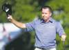 CP
Robert Garrigus acknowledges the fans with his hat and golf ball at the RBC Canadian Open at Hamilton Golf and Country Club's 18th green after shooting a bogey-free 64 to top the leaderboard going into today's final round.