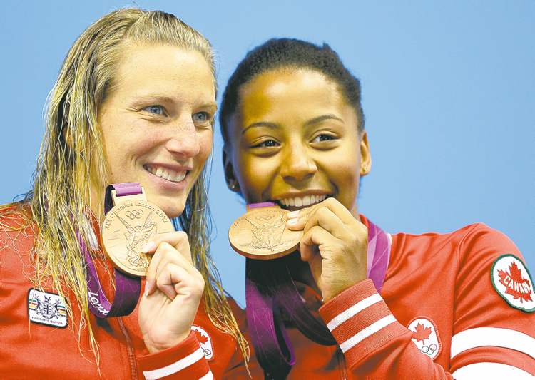 Michael Sohn / The Associated Press
Emilie Heymans (left) and Jennifer Abel show off their bronze medals-- Canada's first hardware from London-- on the podium Sunday.