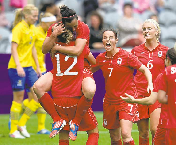 CP
Frank Gunn / The Canadian Press
Canada�s Melissa Tancredi jumps into the arms of Christine Sinclair to celebrate her second goal of the game.