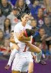 REUTERS
Alessandro Garofalo /reuters
Canada�s Jonelle Filigno flies into the arms of teammate Desiree Scott after Filigno scores against Great Britain.