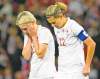 CP
frank gunn / the canadian pressCanadian forwards Christine Sinclair (12) and Sophie Schmidt are shellshocked after the final whistle on Monday.