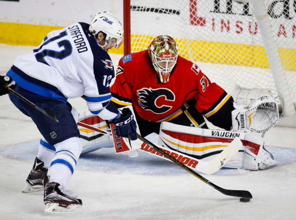 Jeff McIntosh / The Canadian Press
Jets forward Drew Stafford was unable to get this first-period shot past Flames goalie Joni Ortio on Wednesday night.