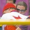 CP
sean kilpatrick / the canadian pressCanada�s Simon Whitfield is hugged by his wife after crashing out of the men�s triathlon during the cycling segment at Hyde Park on Tuesday.