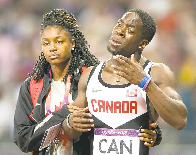 CP
Ryan Remiorz / the canadian press
Justyn Warner is comforted after the Canadian relay team had their third-place finish revoked on Saturday.