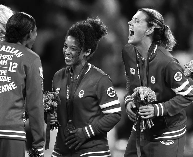 CP
frank gunn / the canadian press archives
Canadian soccer players Robyn Gayle (from left), Desiree Scott of Winnipeg and Christine Sinclair laugh after earning Canada its first-ever medal in women�s soccer.