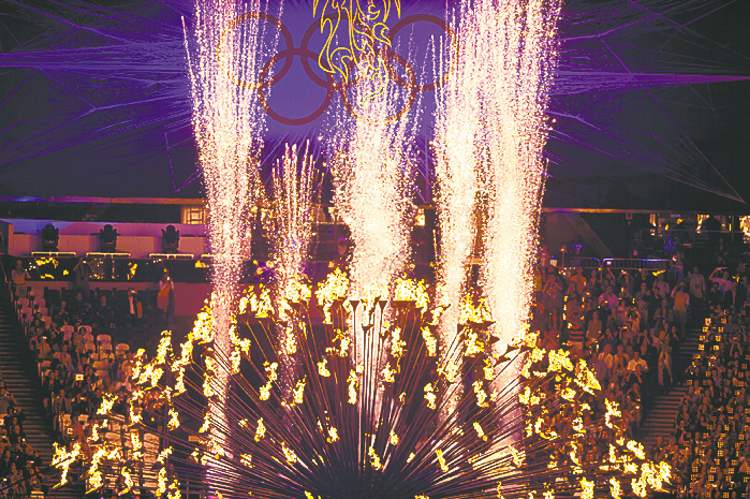 DAVID EULITT / KANSAS CITY STAR
The Olympic cauldron is opened up before before being extinguished at the end of the games.