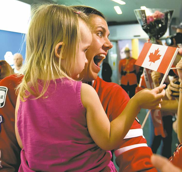 CP
darryl dyck / the canadian press
Canadian women�s soccer team captain Christine Sinclair holds her two-year-old niece Kaitlyn Sinclair as she returns to Vancouver International Airport.