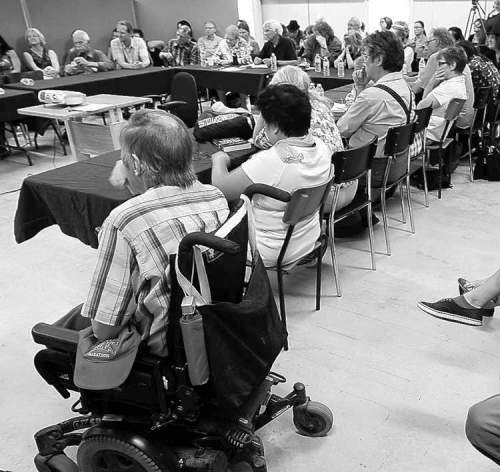 A packed house listens to experts discuss guaranteed incomes at a Winnipeg forum.