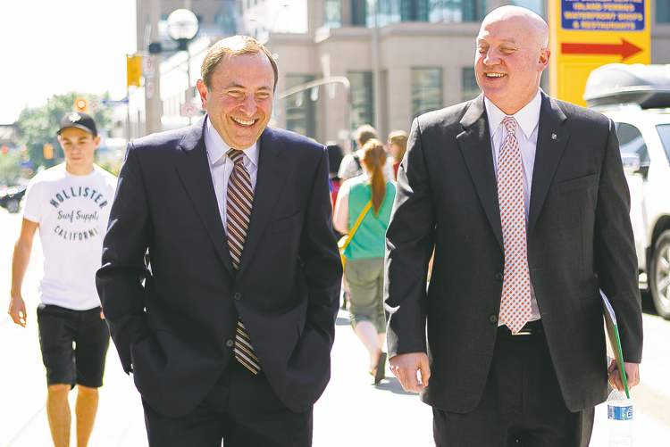CP
Chris Young / The Canadian Press
The NHL�s Gary Bettman (left) and Bill Daly leave the NHLPA offices in Toronto Wednesday. They probably weren�t this happy behind closed doors.