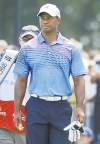 henny ray abrams / the associated press
Tiger Woods played with back pain all day, and still managed to stay in contention.