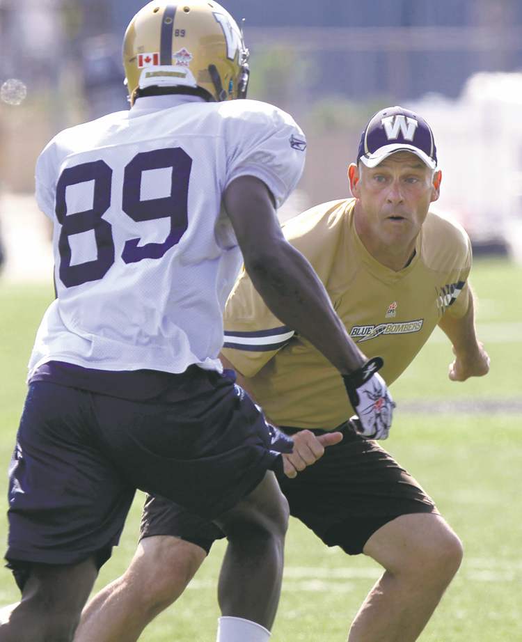 WAYNE GLOWACKI / WINNIPEG FREE PRESS
Blue Bombers offensive co-ordinator Gary Crowton works with slotback Clarence Denmark at practice Wednesday.