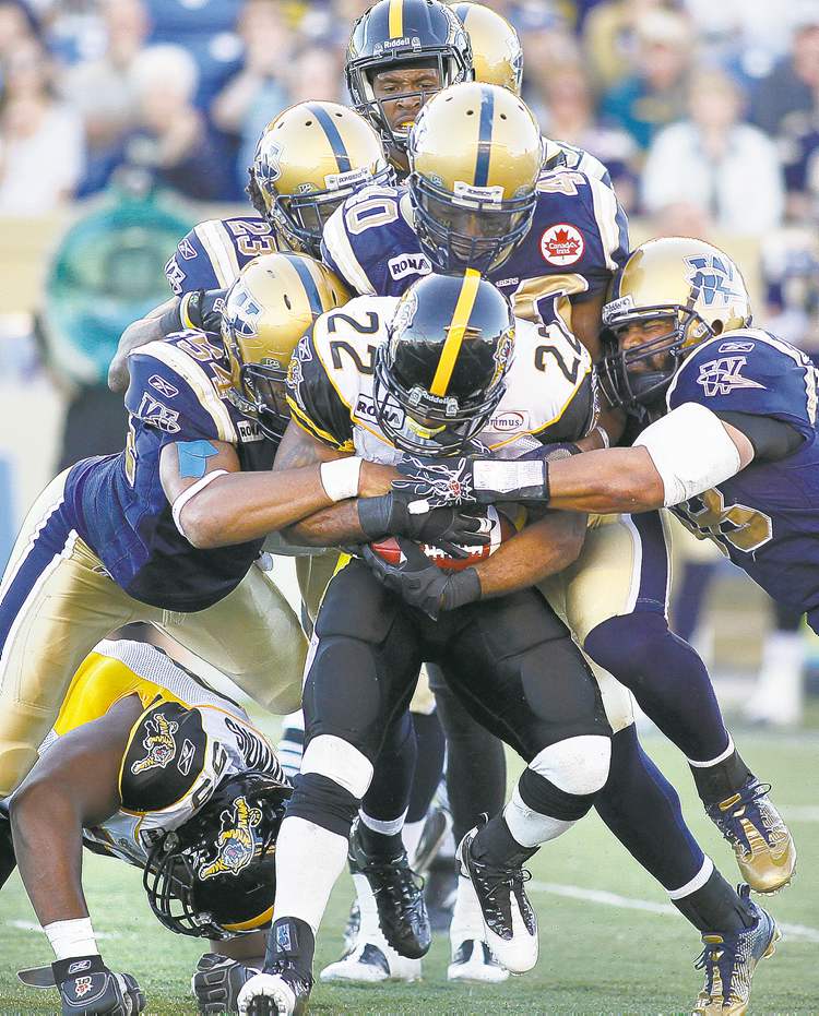 Winnipeg Free Press
Blast from the past: the Winnipeg defence gang tackles Hamilton running back Avon Cobourne in 2011.