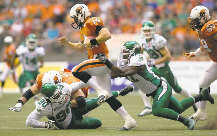 CP
darryl dyck / the canadian press archives
B.C. Lions quarterback Travis Lulay is hauled down in the backfield by Saskatchewan Roughriders rush end Odell Willis (right) earlier this season in Vancouver. Willis has four sacks so far.