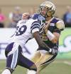 TREVOR HAGAN / WINNIPEG FREE PRESs
Bombers QB Buck Pierce takes in on the chin from Argos' Brandon Isaac.