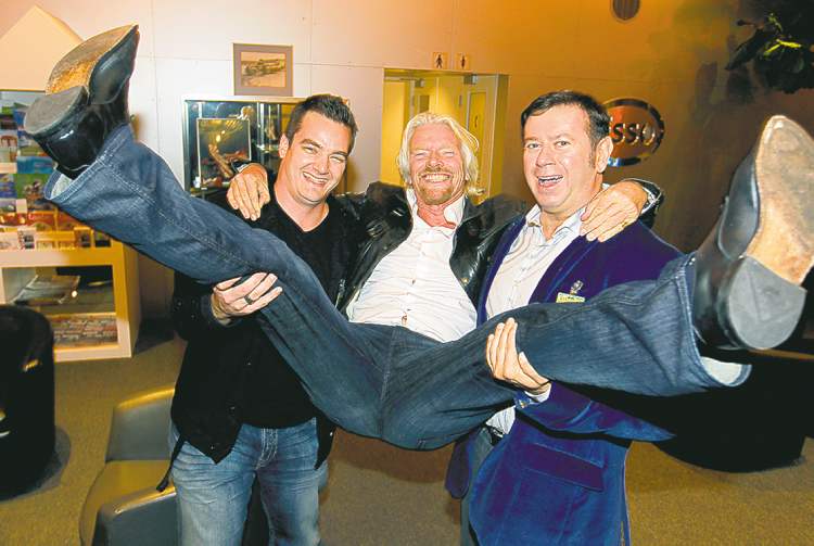 Winnipeg Free Press
BORIS MINKEVICH / WINNIPEG FREE PRESS
Sir Richard Branson is hoisted by Virgin Radio Winnipeg brand director Dale Davies and Virgin Radio Canada�s executive vice-president of content programming Rob Farina in Winnipeg.