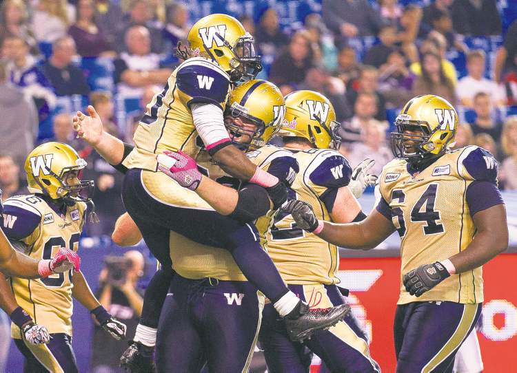 CP
Nathan Denette / The Canadian Press Archives
Blue Bombers running back Will Ford celebrates his touchdown with linemen Justin Sorensen and Chris Greaves last game vs. Toronto. The hogs are getting the job done.