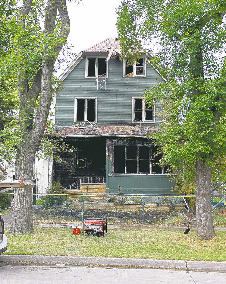 Witnesses saw a woman set the rooming house on fire.