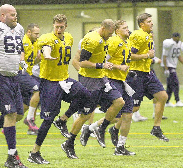 JOE BRYKSA / WINNIPEG FREE PRESS
Blue quarterbacks (front, left to right) Justin Goltz, Alex Brink, Joey Elliott and R.J. Archer and Buck Pierce (4) kept loose at Tuesday's indoor workout.