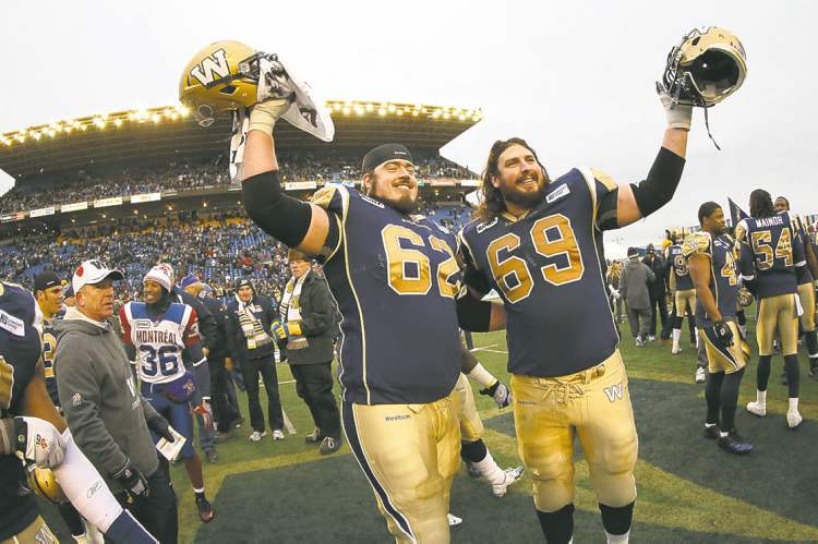 Trevor Hagan / Winnipeg Free Press
Winnipeg Blue Bombers' Steve Morley (62) and Glenn January (69) salute the crowd following the teams victory in the final game at Canad Inns Stadium, Saturday, November 3, 2012.