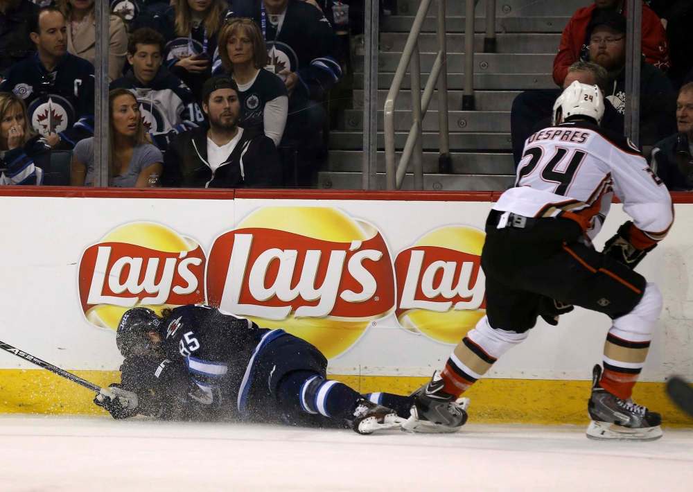 TREVOR HAGAN / THE CANADIAN PRESS
Mathieu Perreault (85) suffered a concussion after hitting boards awkwardly during Sunday's game against Anaheim.