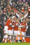 Sang Tan / The Associated Press
Arsenal players celebrate one of their quintet of goals against Tottenham Hotspur on Saturday.