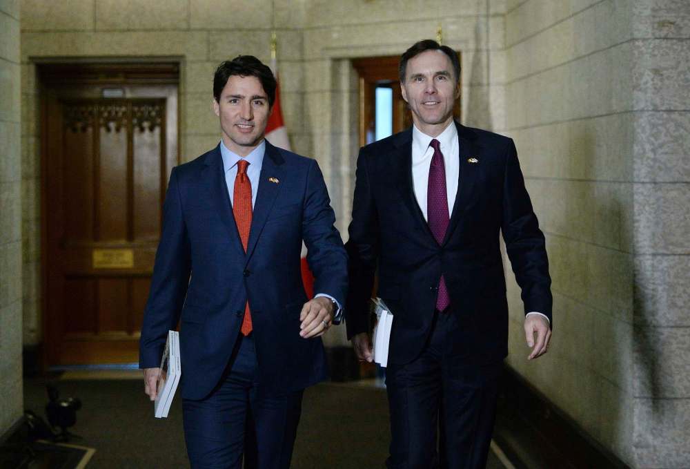 Sean Kilpatrick / The Canadian Press
Minister of Finance Bill Morneau, right, is accompanied by Prime Minister Justin Trudeau as he makes his way to deliver the federal budget in the House of Commons on Parliament Hill in Ottawa on Tuesday, March 22, 2016.