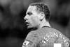 Clint Hughes / The Associated Press
Manchester United's Rio Ferdinand walks off the pitch Sunday after he is hit in the face by a coin.